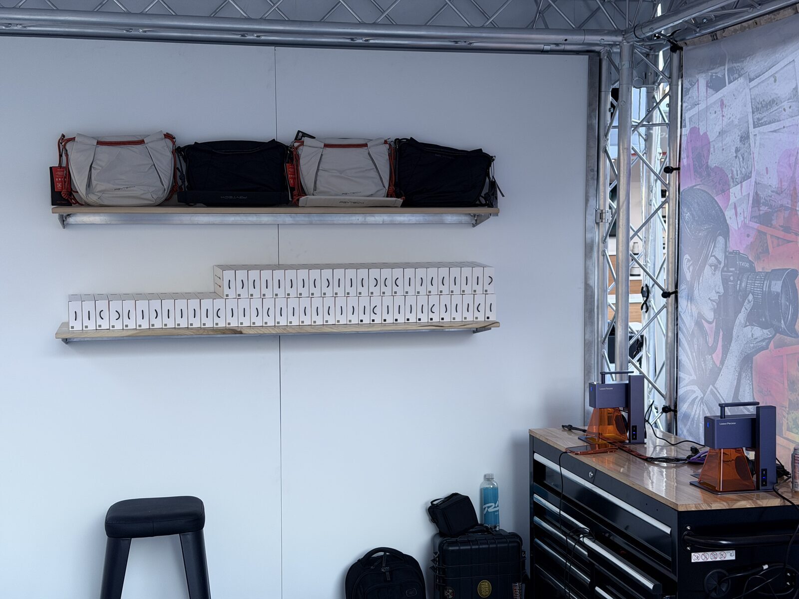 Blank caps racked on a white display wall ready for a live hat bar