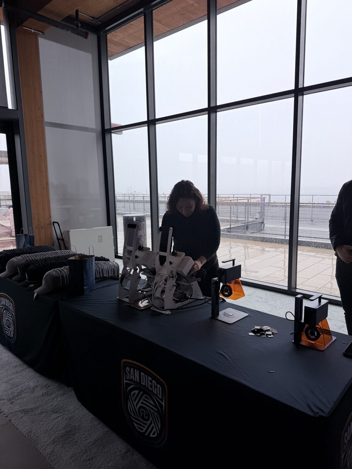 Daylight hat-press station set up at a rooftop LA event